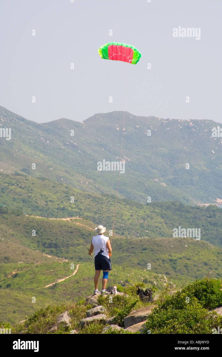 Hong Kong hiking flying double line stunt kite on hilltop with hiking