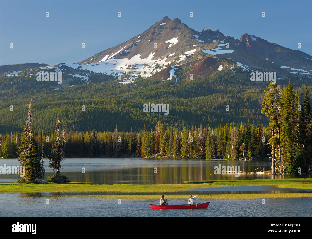 Pair canoeing on Sparks Lake Deschute National Forest with snow capped