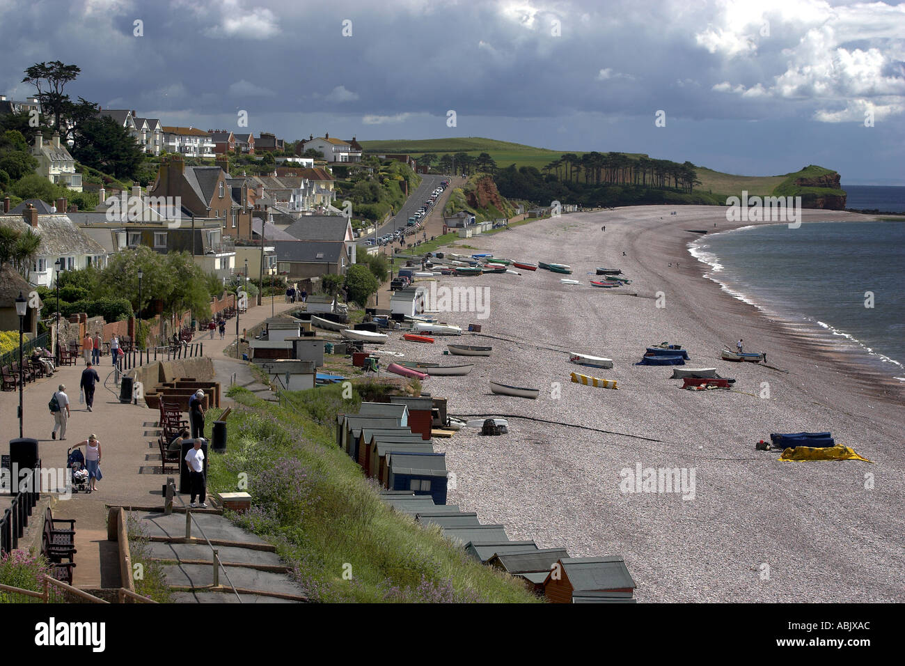 Walkers on the foot path beside the beach of the coastal resort of