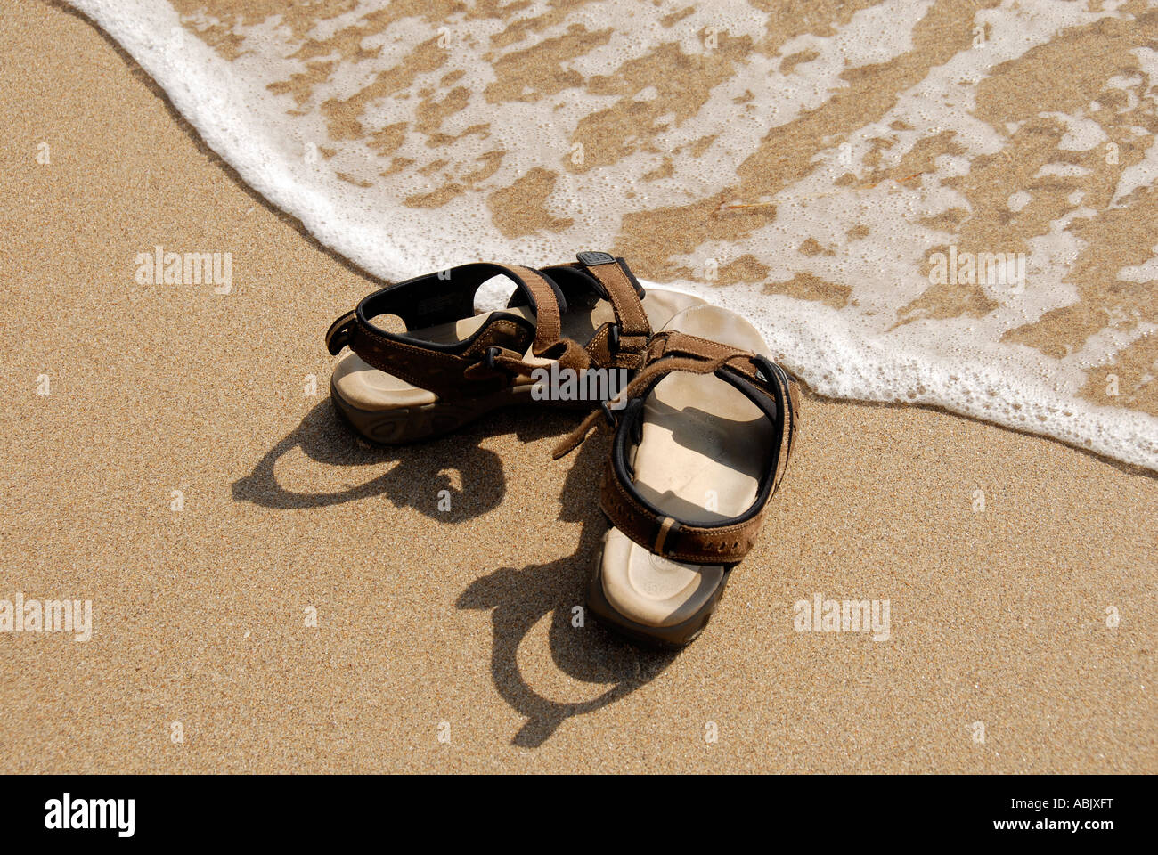 Sandals on the beach Stock Photo - Alamy