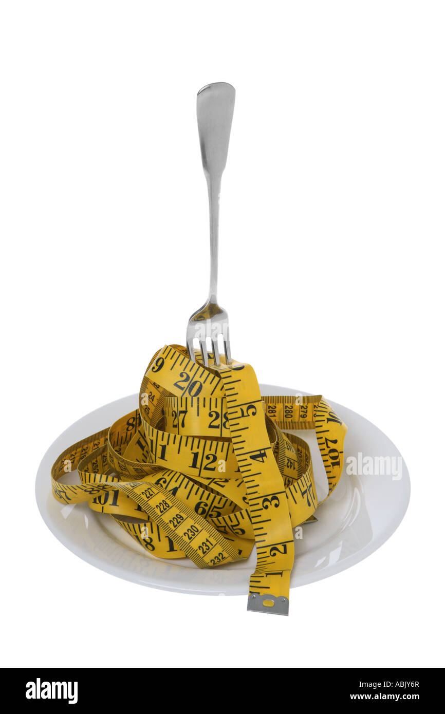 Tape measure with fork on plate cut out on white background Stock Photo