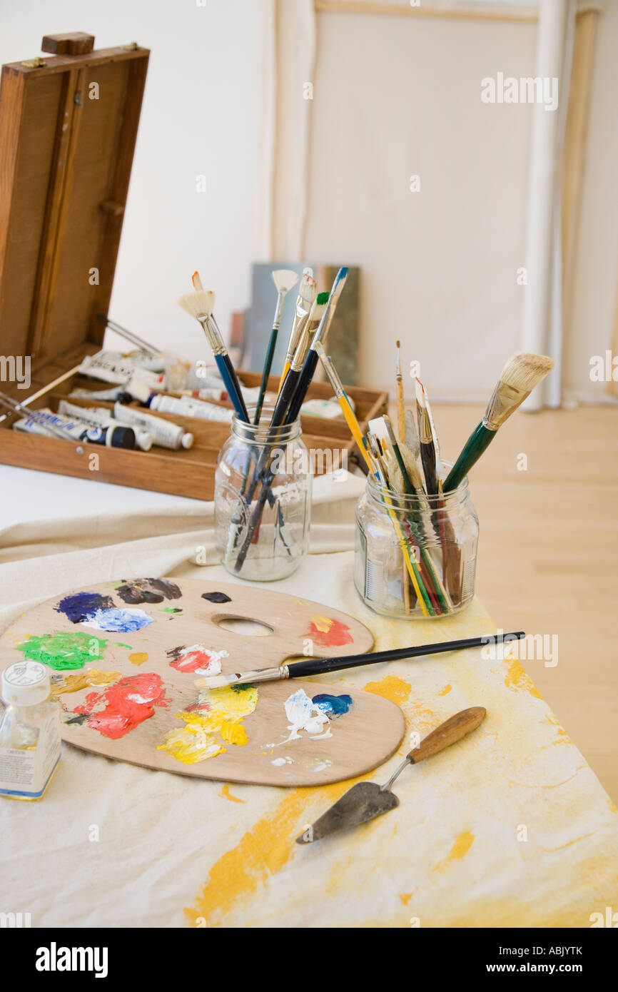 Artist s palette and paintbrushes on table Stock Photo Alamy
