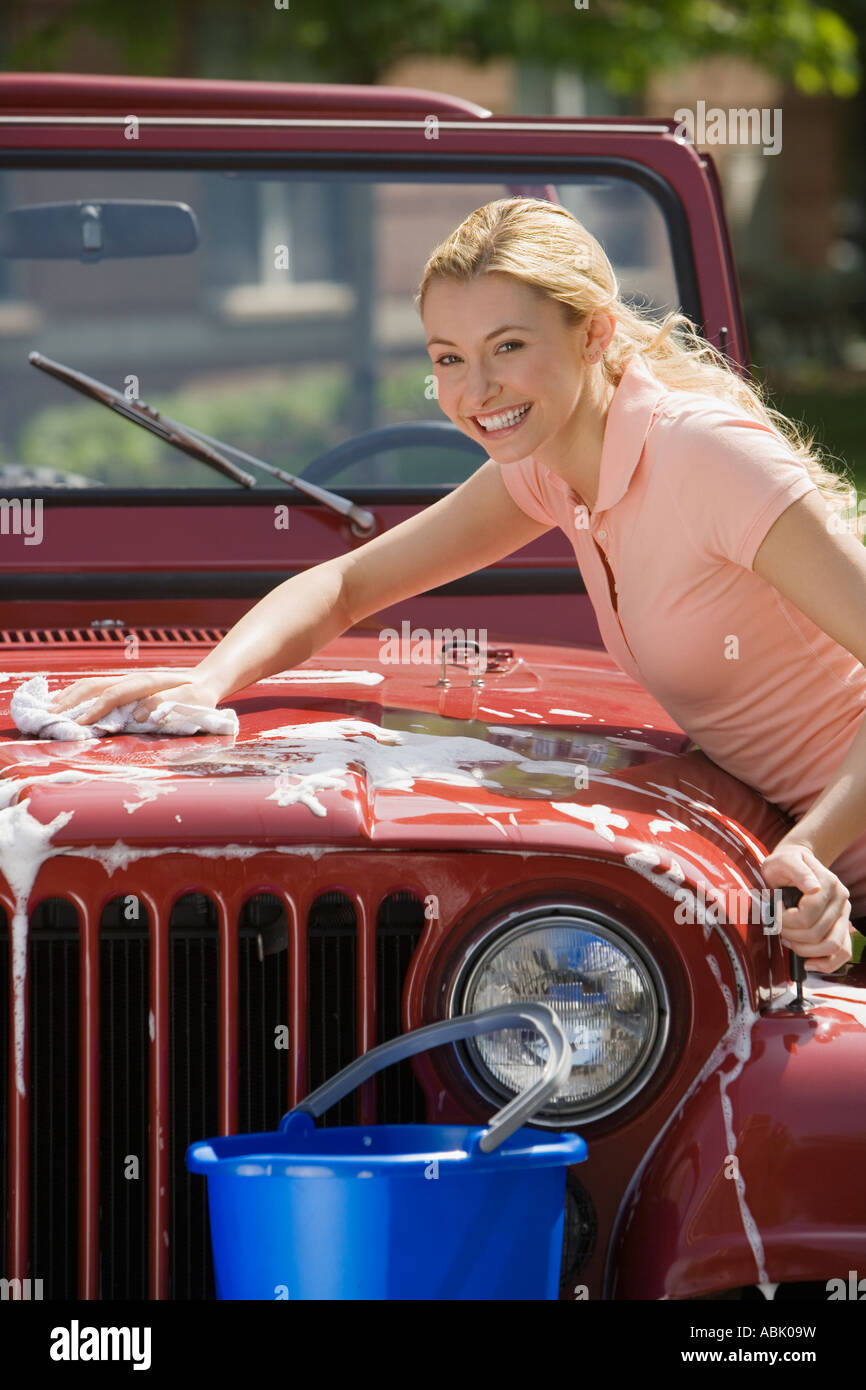 Woman washing jeep Stock Photo Alamy