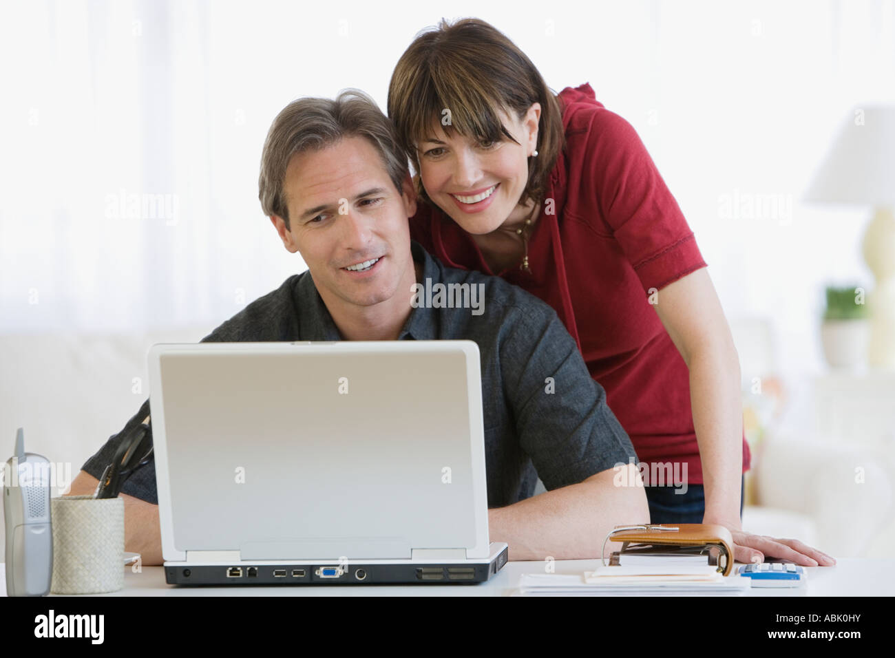 Couple looking at laptop Stock Photo - Alamy
