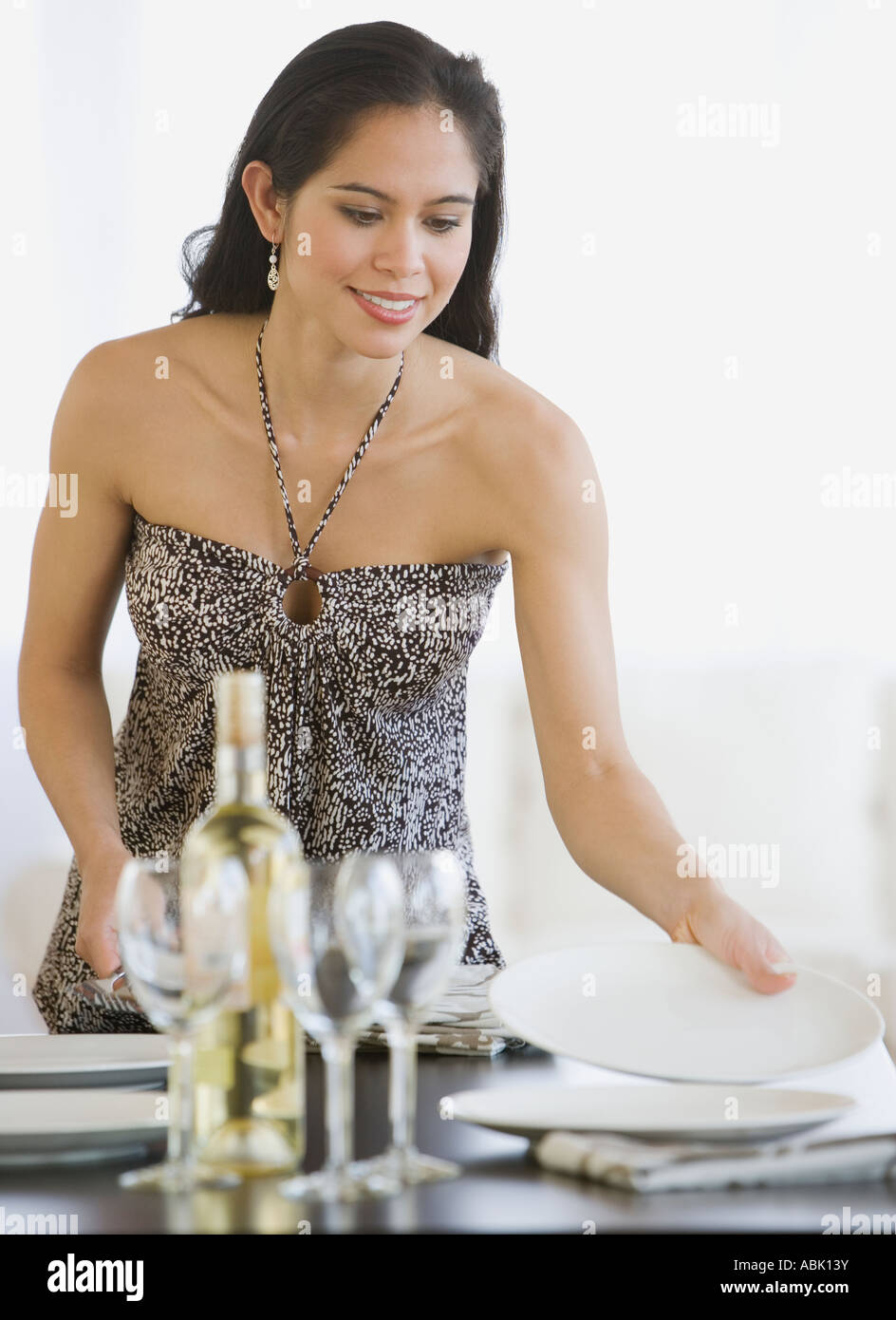 Woman setting table Stock Photo - Alamy