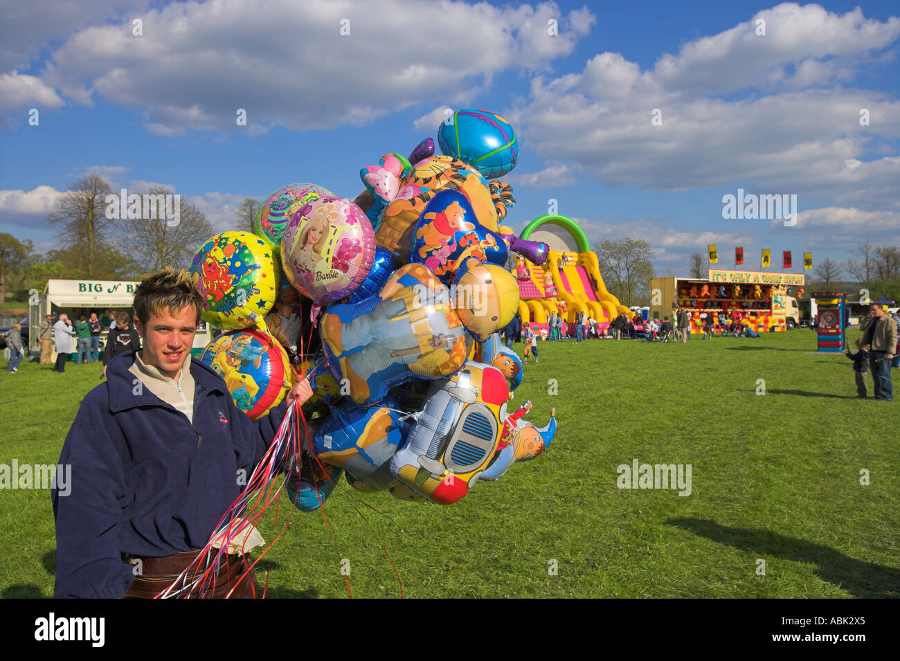 Smiling Balloon salesman at fairground Stock Photo