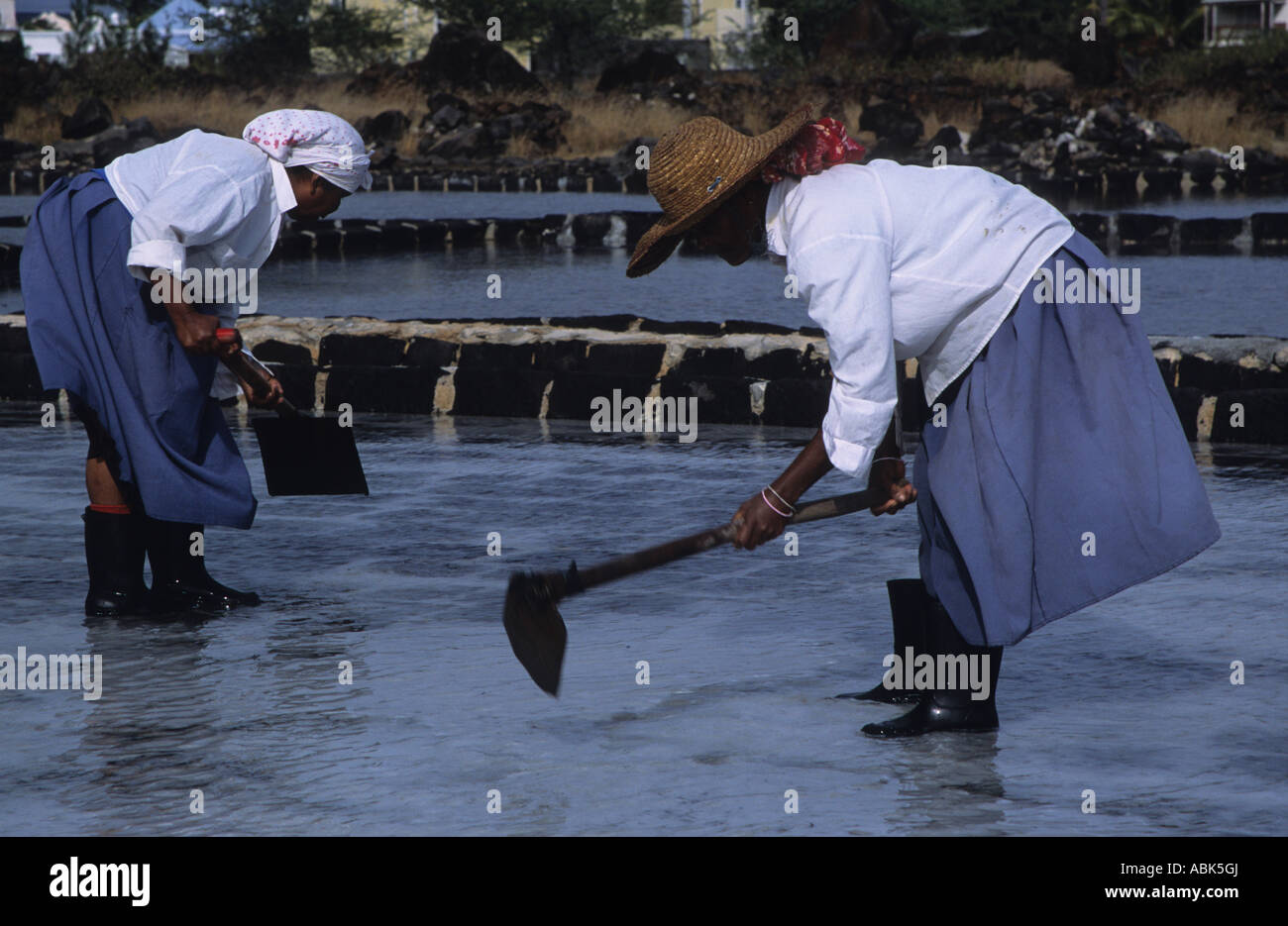 Two women working on the salt pans, Tamarin, North Black River, Mauritius, Indian Ocean, Africa Stock Photo
