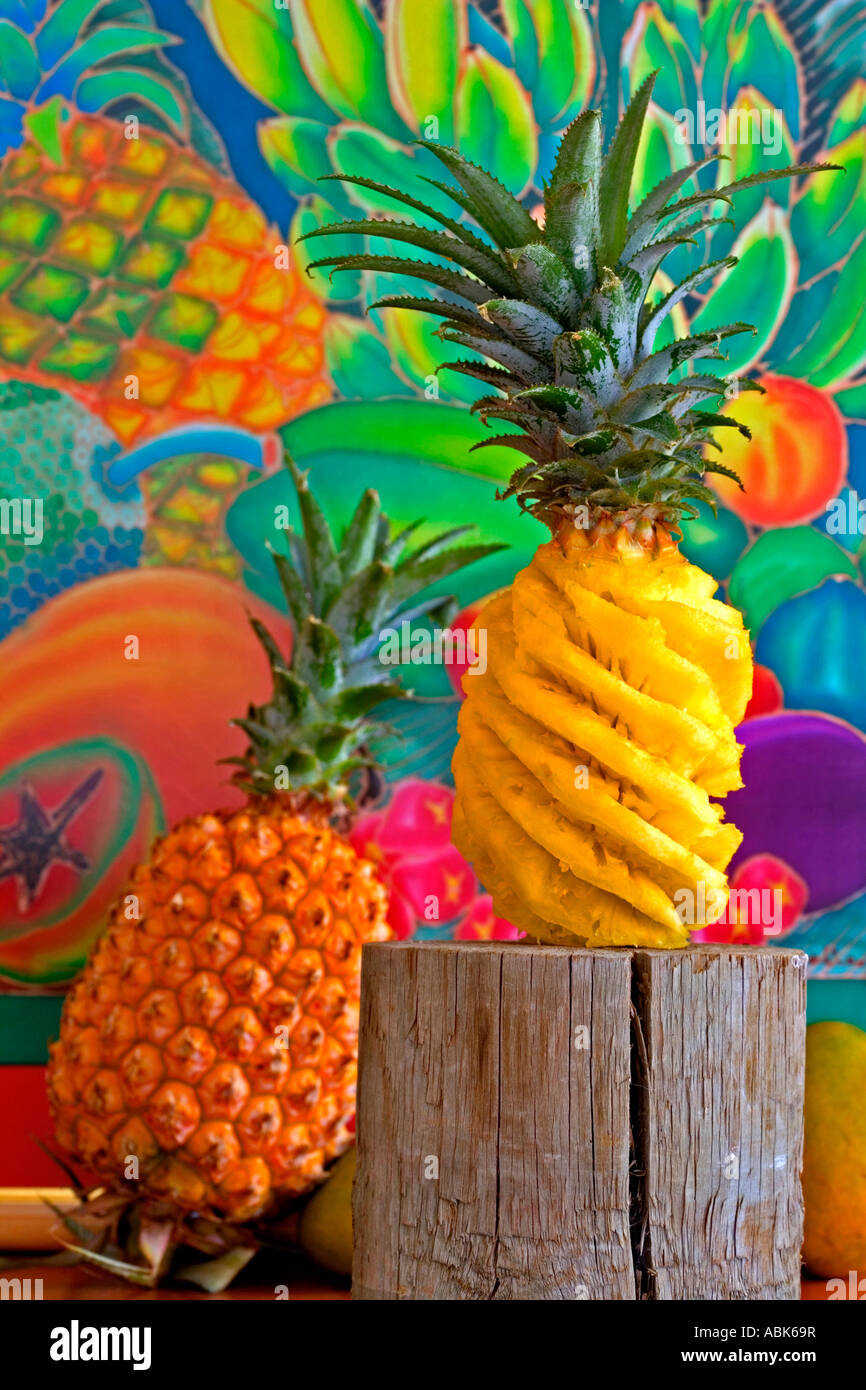 Still life Pineapples one spiral cut against tropical backdrop ...