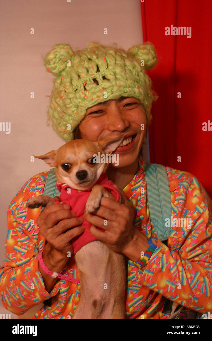 japanese male dressed in day glo with his dog Stock Photo Alamy