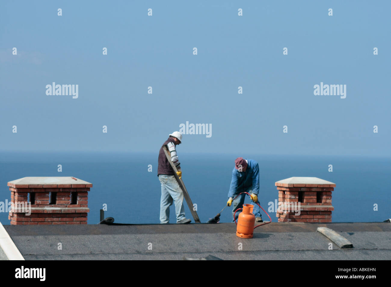 Men working on roof in sunny Dubrovnic, Croatia Stock Photo