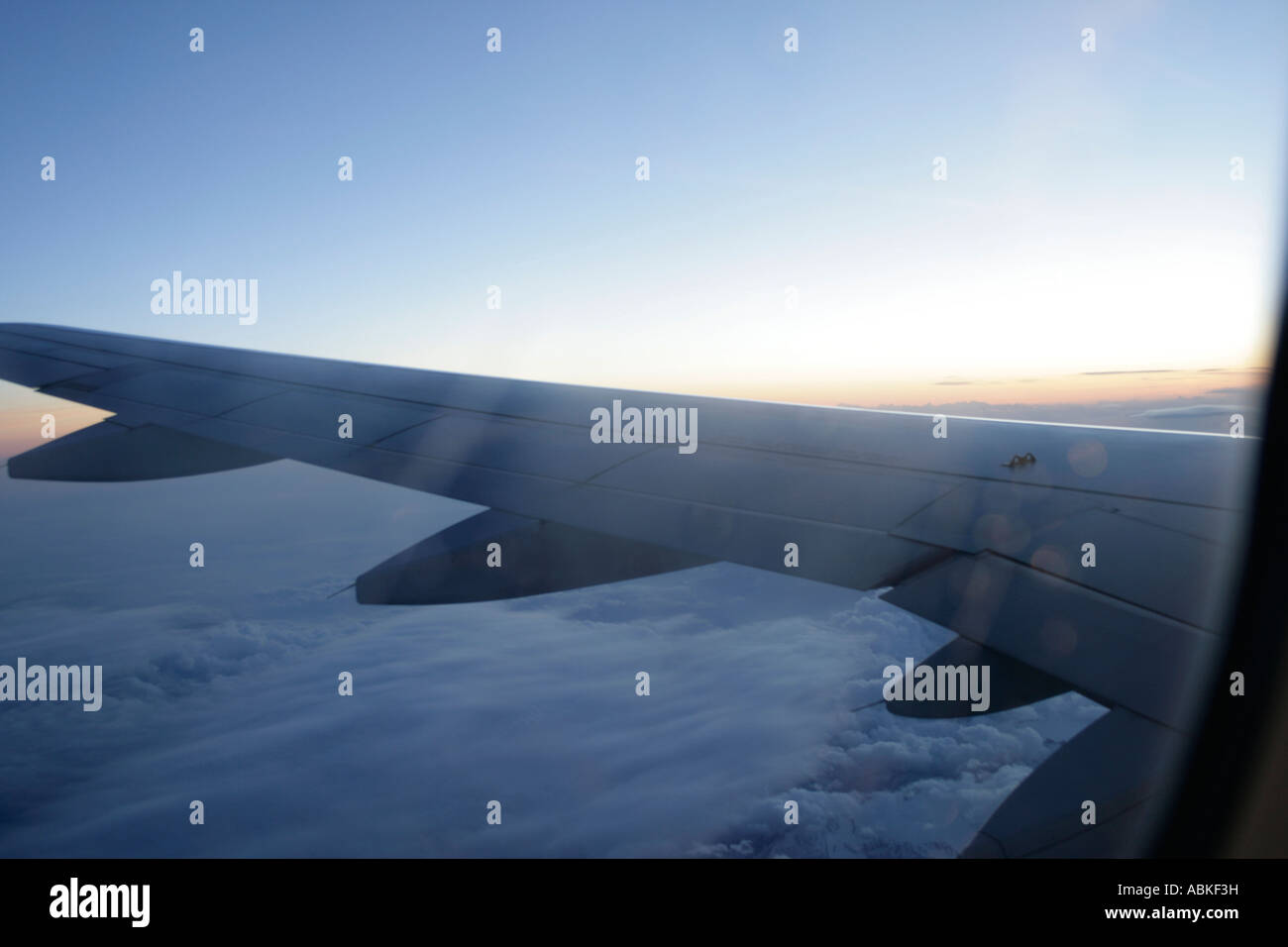 View of airplane wing in flight above the clowds Stock Photo - Alamy