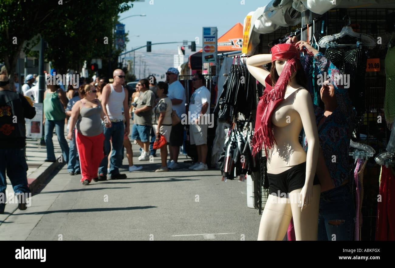 Shop owner dresses a female mannequin during the annual independence rally in Hollister, CA. Photo by Chuck Nacke Stock Photo