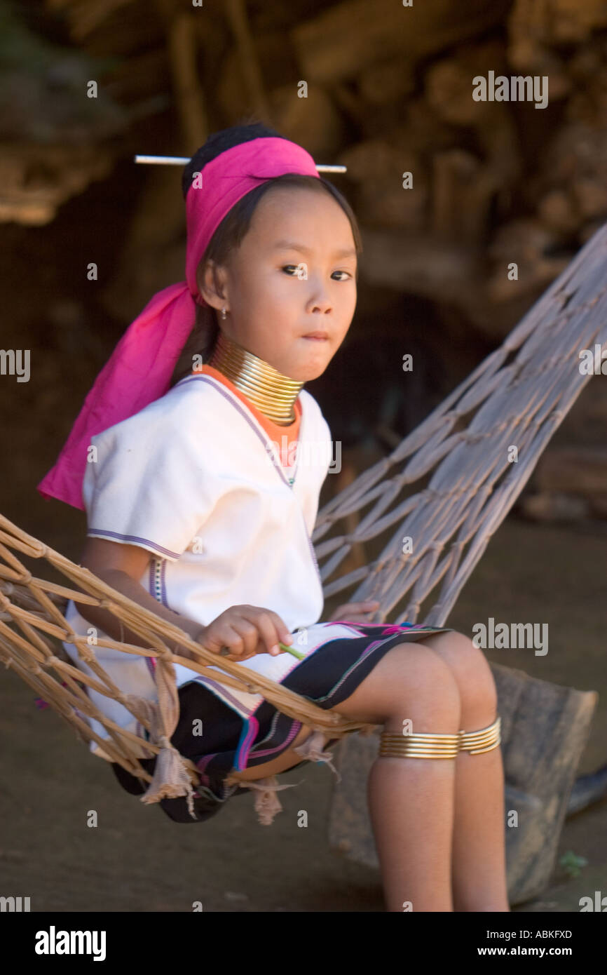 Young kareni long neck girl with brass coils around her neck sad look emotion on face thailand