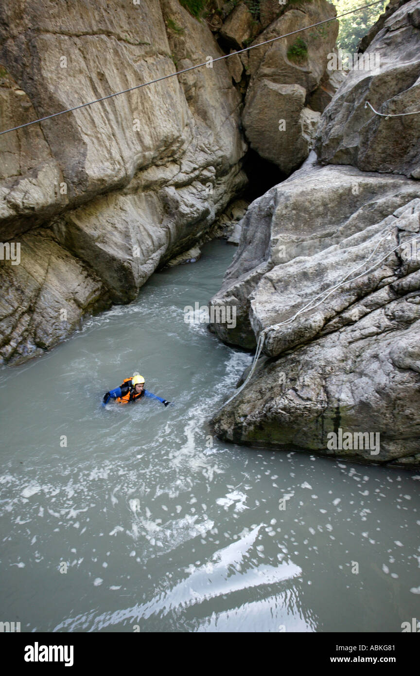 Tourist jumping into river in canyoning adventure Chateau D Oex village in Pays d Enhaut Bernese Oberland Switzerland Europe Stock Photo