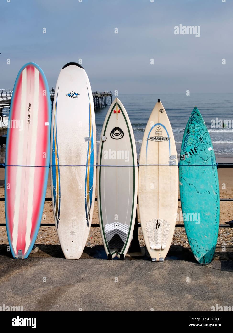 Surf boards tied against seaside hand rail outside the surf shop at  Saltburn Cleveland UK Stock Photo - Alamy