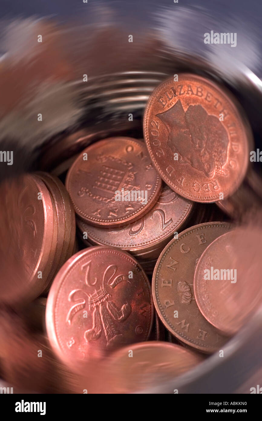 Tin of  British uk one penny and tuppenny pieces Stock Photo