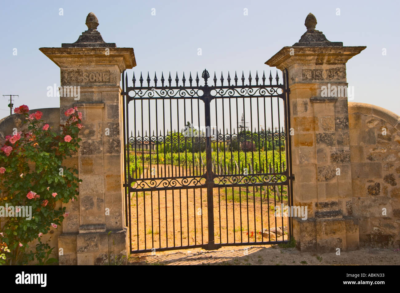 An iron gate and stone gate posts inscribed with ausone to the