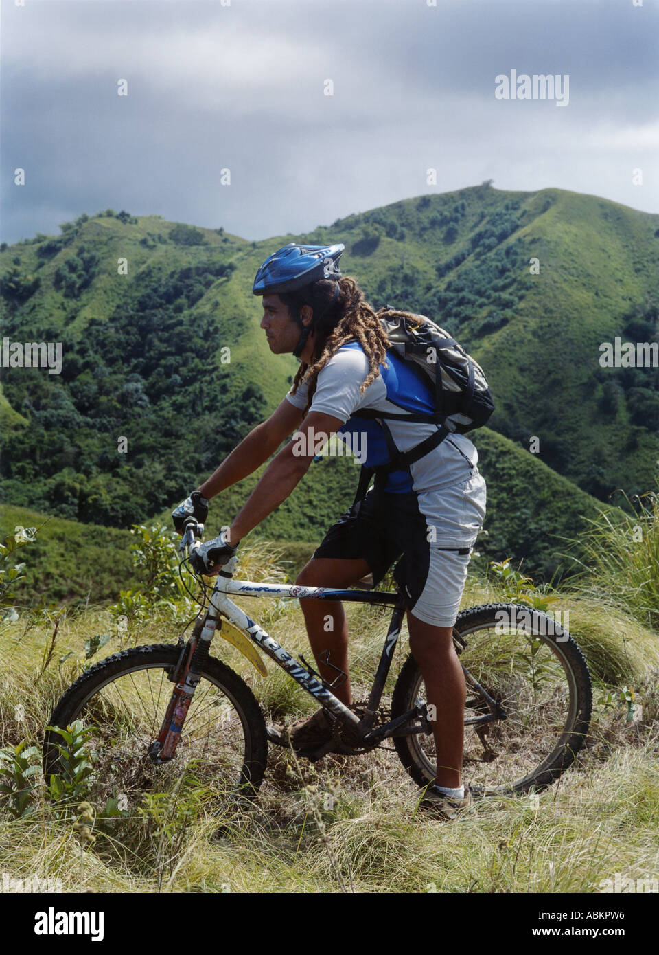 Over Bike Riding Man riding his bike over the hills in Tobago, Caribbean island Stock ...