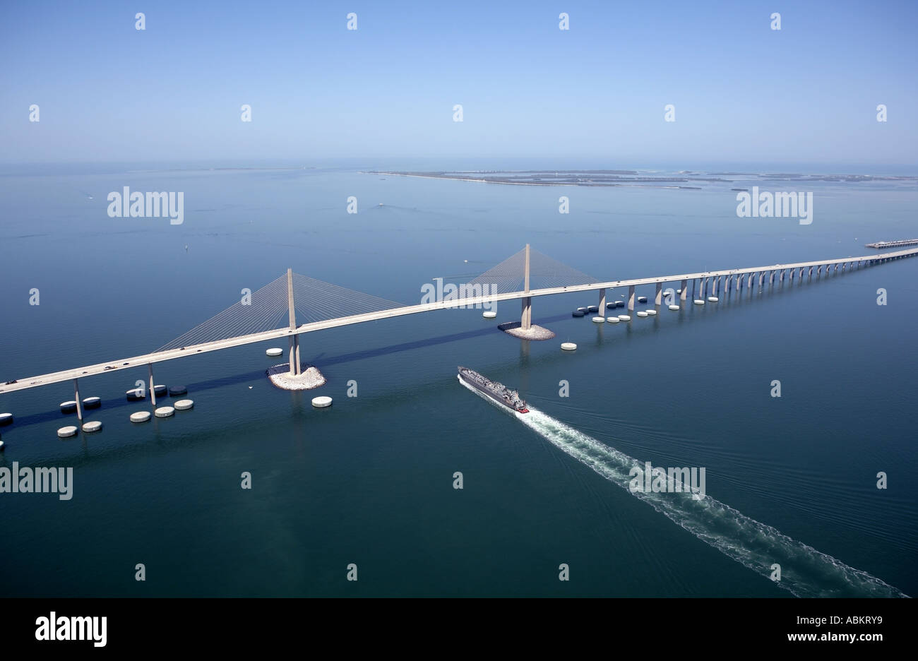 Scenic aerial photo of Sunshine Skyway Bridge and cargo ship passing