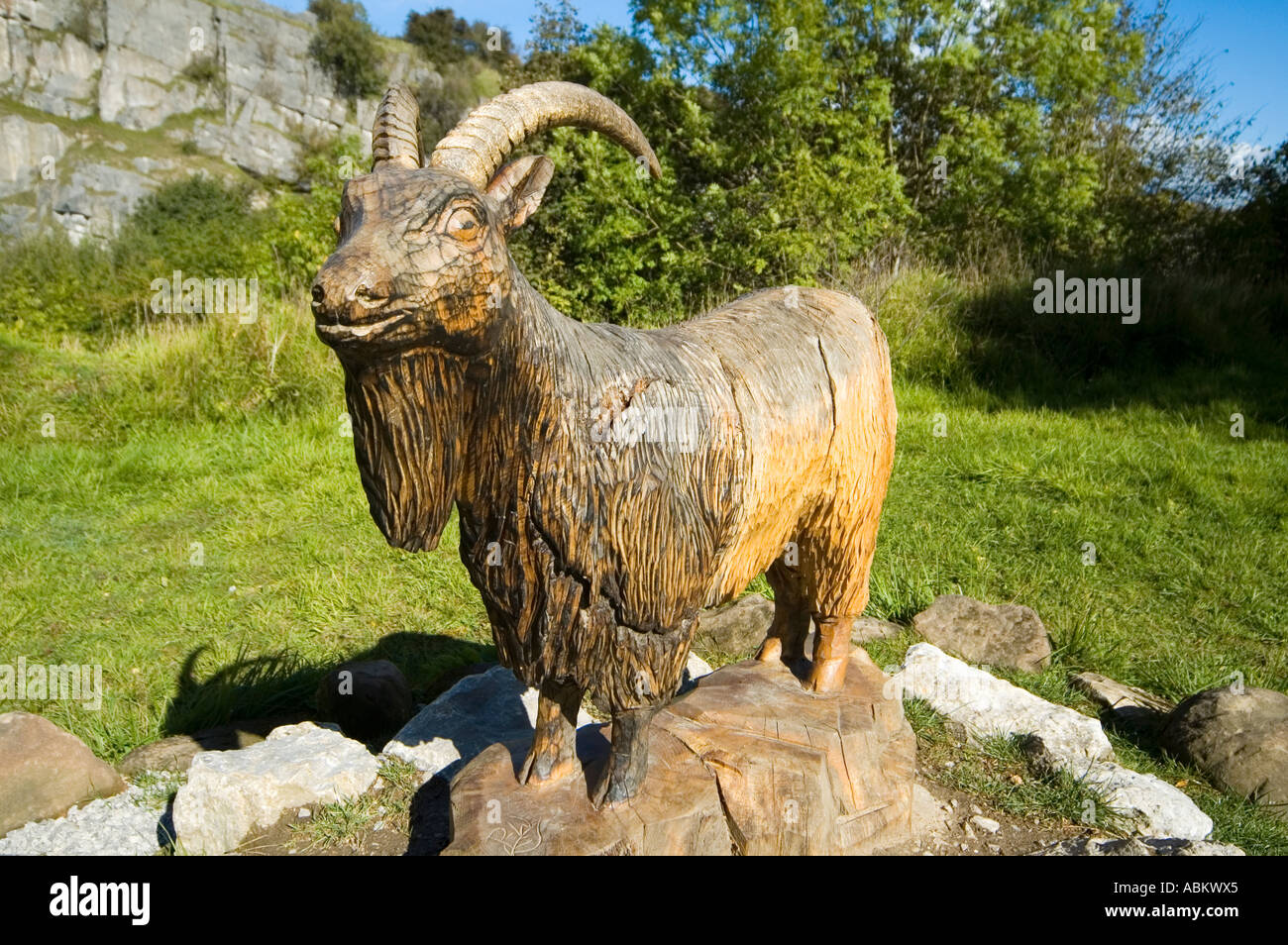 Wood carving of a goat, on the Sculpture Trail at the Crich Tramway Village, near Matlock, Derbyshire, England, UK Stock Photo