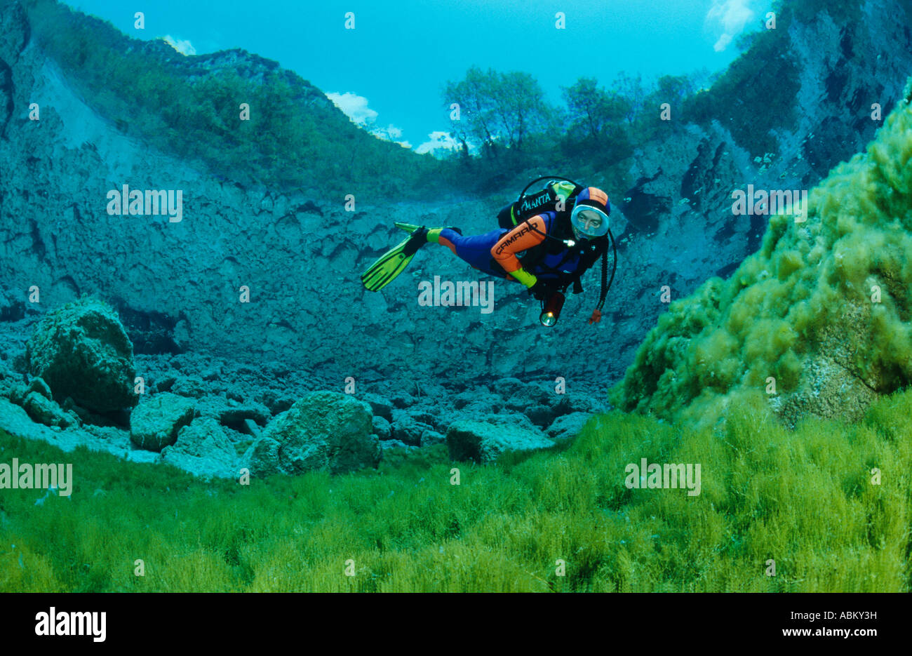 scuba diver in crystal clear mountain lake Stock Photo