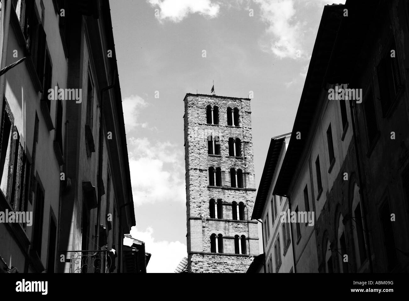 A historical street in Arezzo, Tuscany, Italy with traditional buildings and a church Stock Photo
