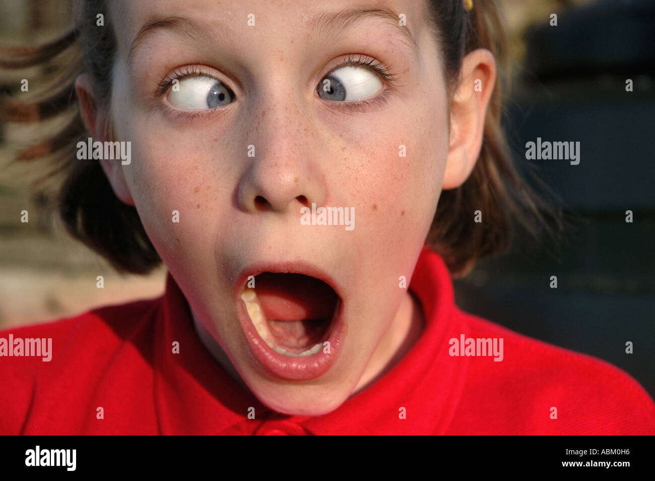 portrait of child pulling a funny face and looking shocked Stock Photo