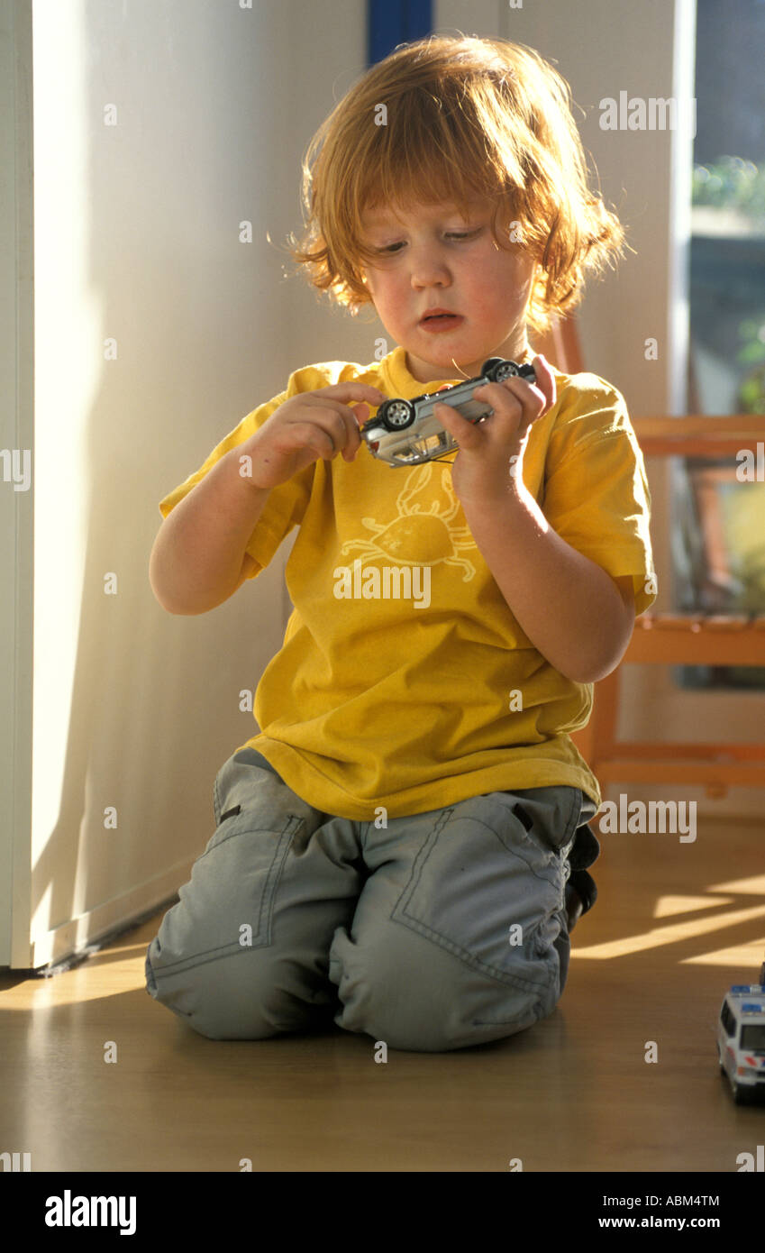 Little boy is playing on the floor with toy cars Stock Photo - Alamy