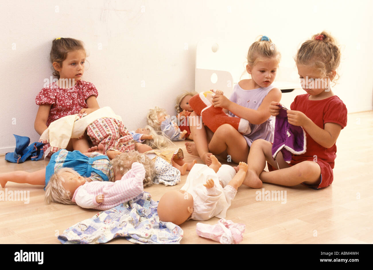Little girls playing with their dolls Stock Photo