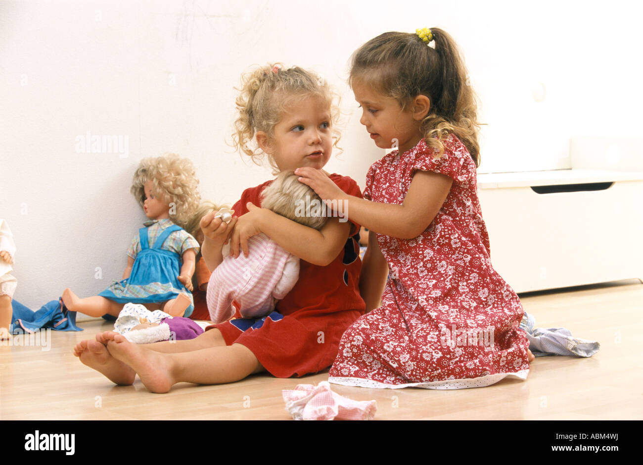 little girls playing with baby dolls