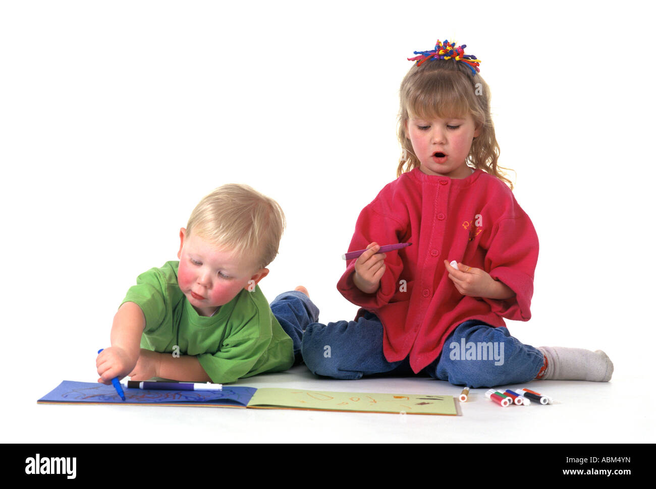 Two children are making a drawing Stock Photo - Alamy