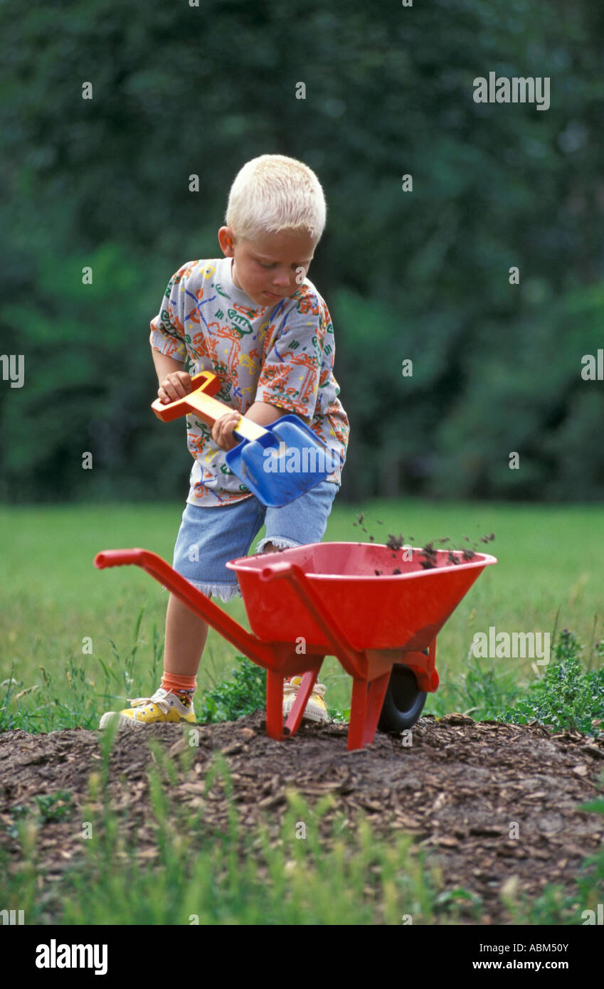 Little boy with a wheelbarrow Stock Photo - Alamy