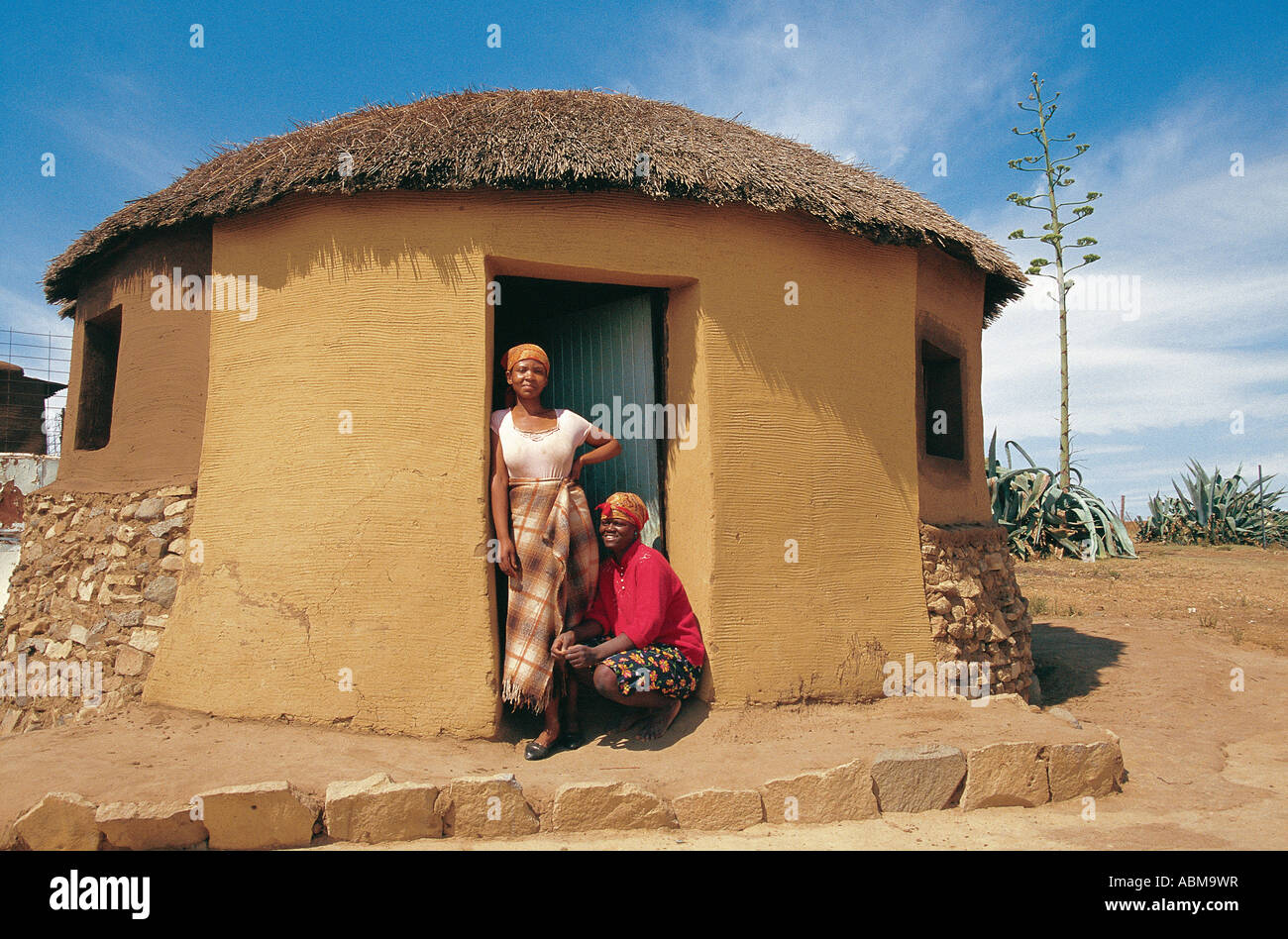 Two young women at the dorway of their home S sutu Lesotho Stock Photo