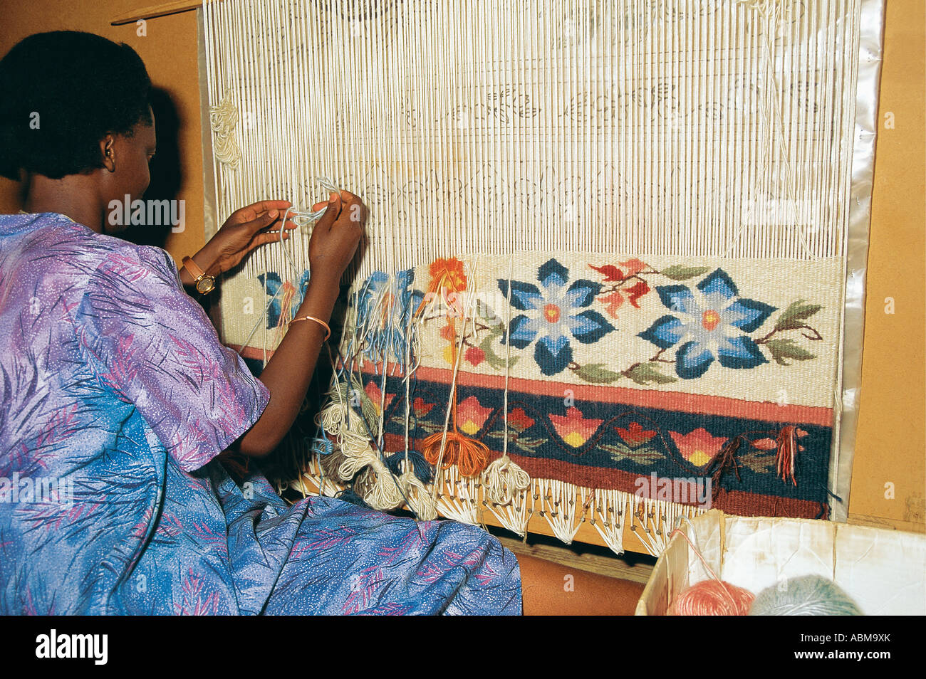 Woman at work carpet weaving with angora wool Lesotho Stock Photo