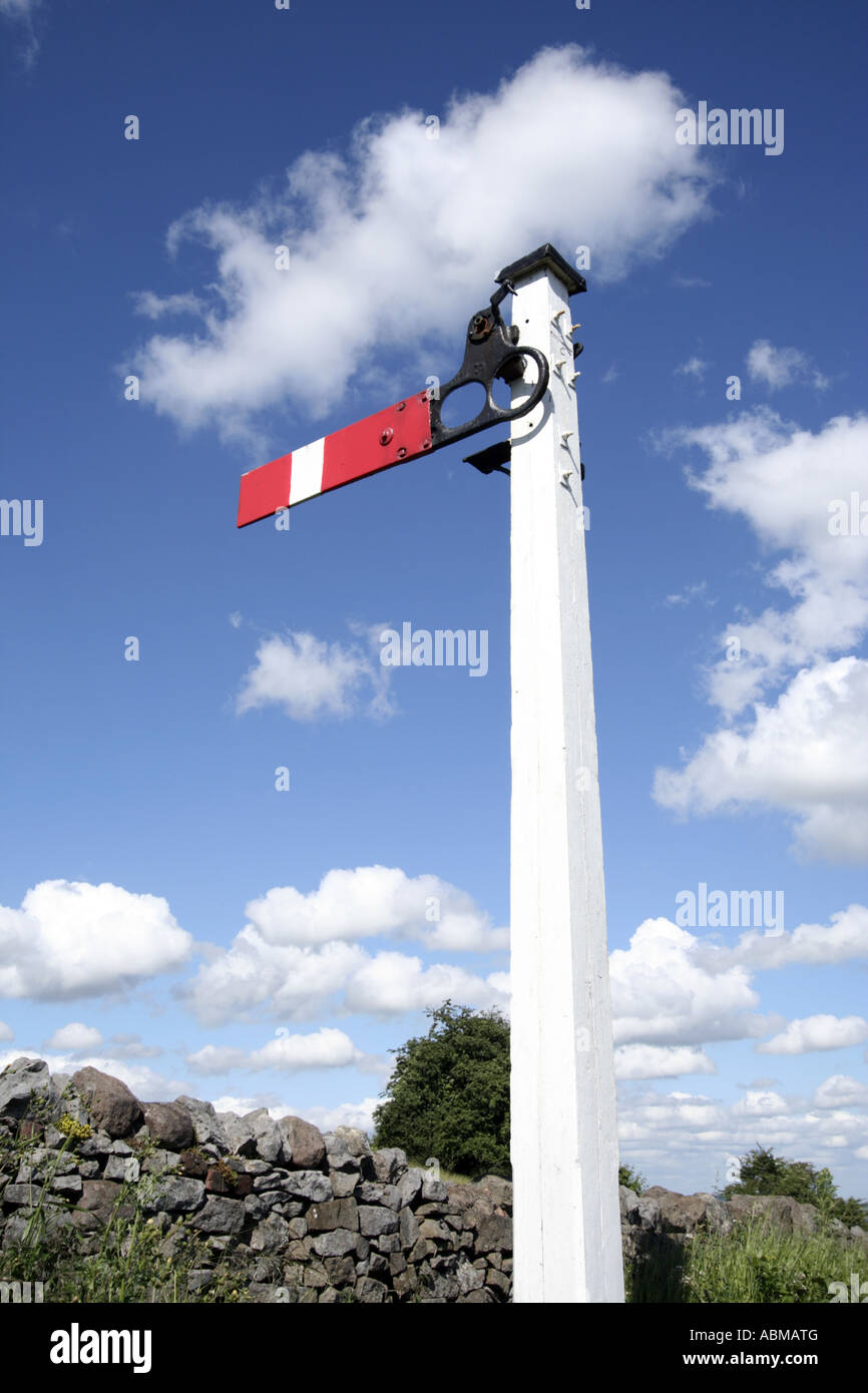 Red and White railway Signal in a blue sky Stock Photo