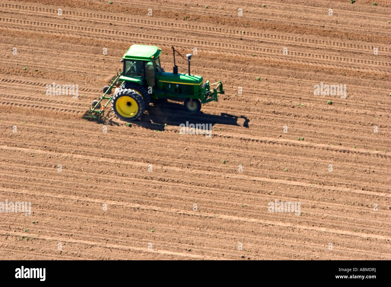 Aerial view of a farmer on a tractor spring tilling a field in Canyon County Idaho Stock Photo