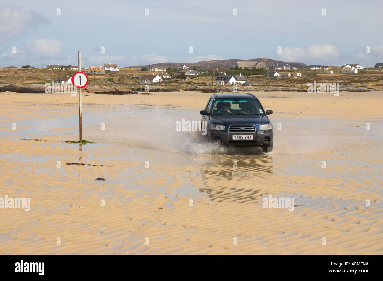 Car crossing the strand to Omey island at low tide  Connemara  Ireland Stock Photo