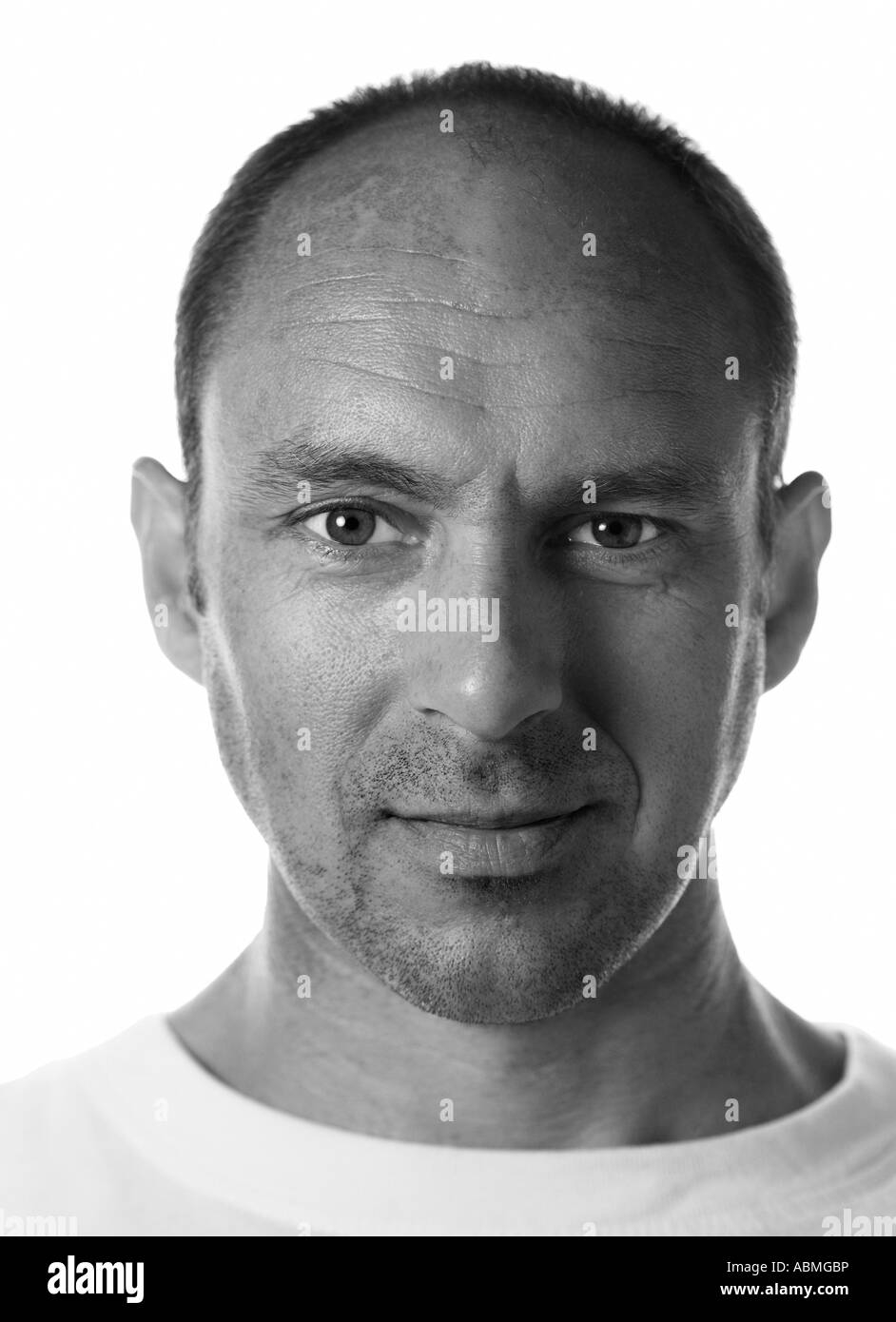 Vertical, black and white head shot of a man in his thirties. Stock Photo