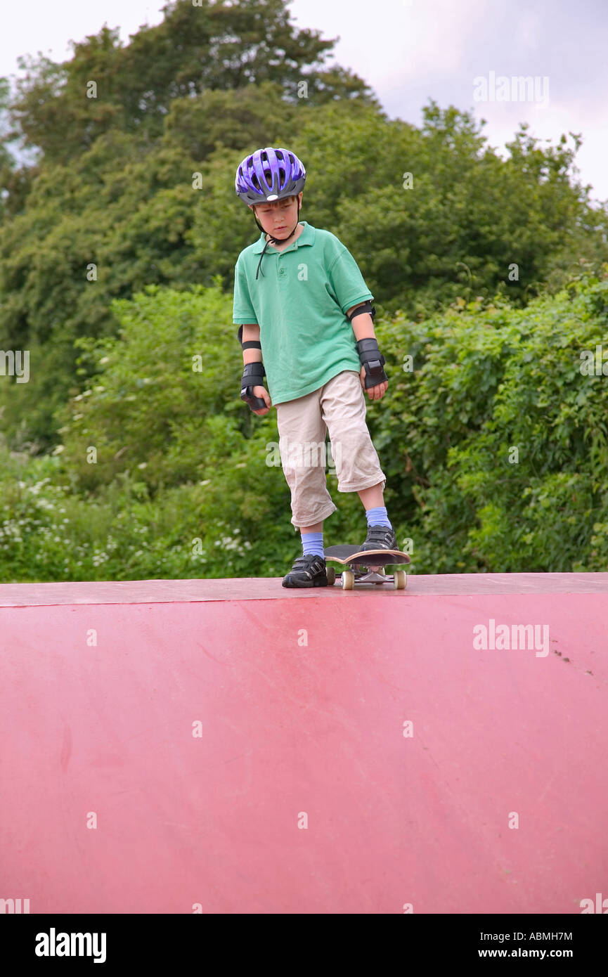 Boy preparing to go down a ramp on his skateboard Stock Photo Alamy
