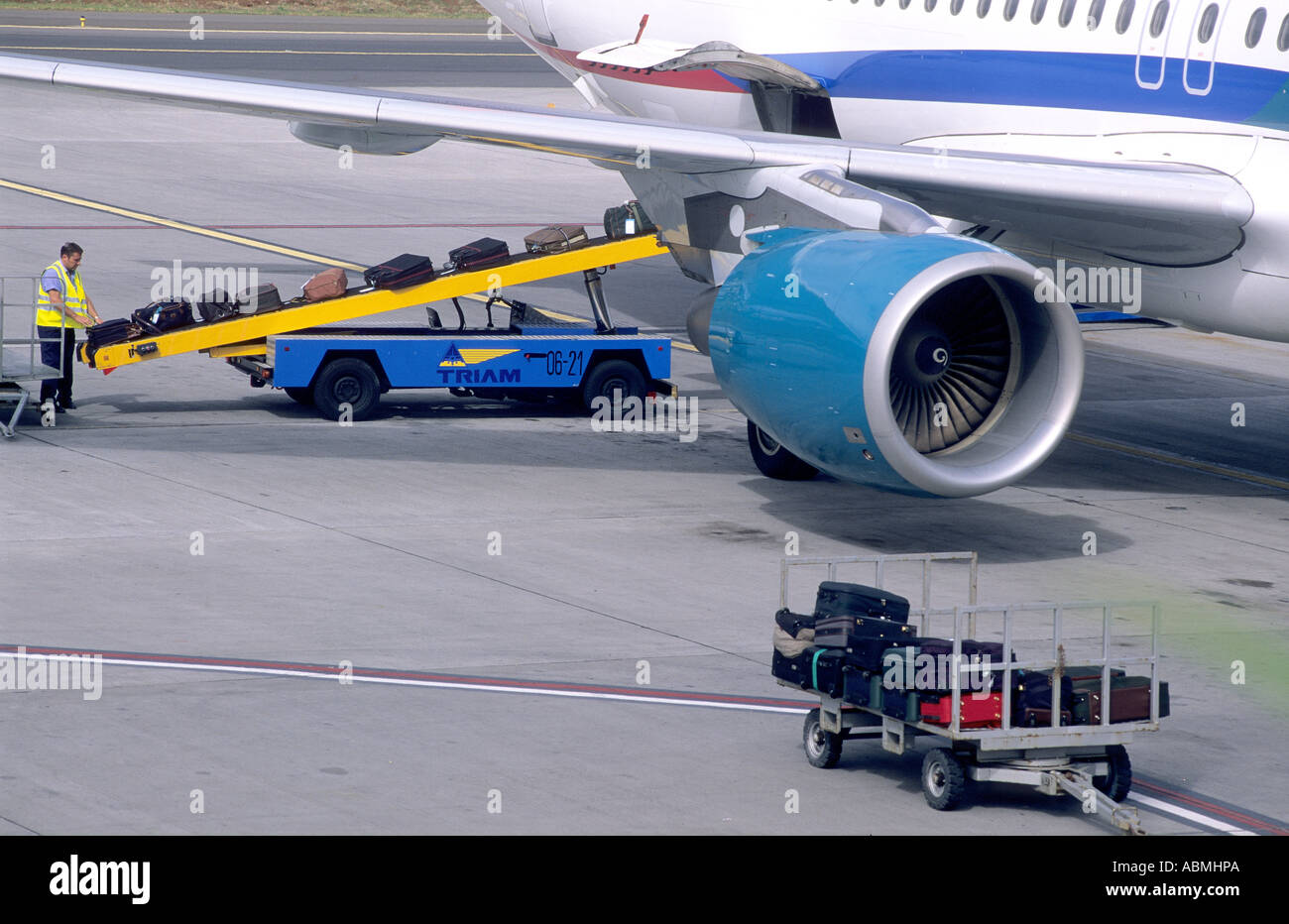 Airport staff loading airplane with baggage. Funchal, Madeira Stock