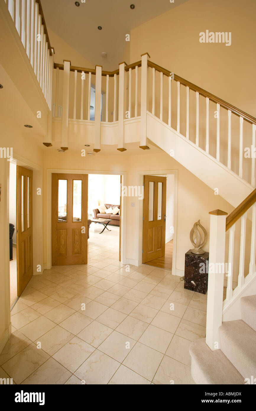 entrance hall of large modern home with balcony stairway Stock Photo ...