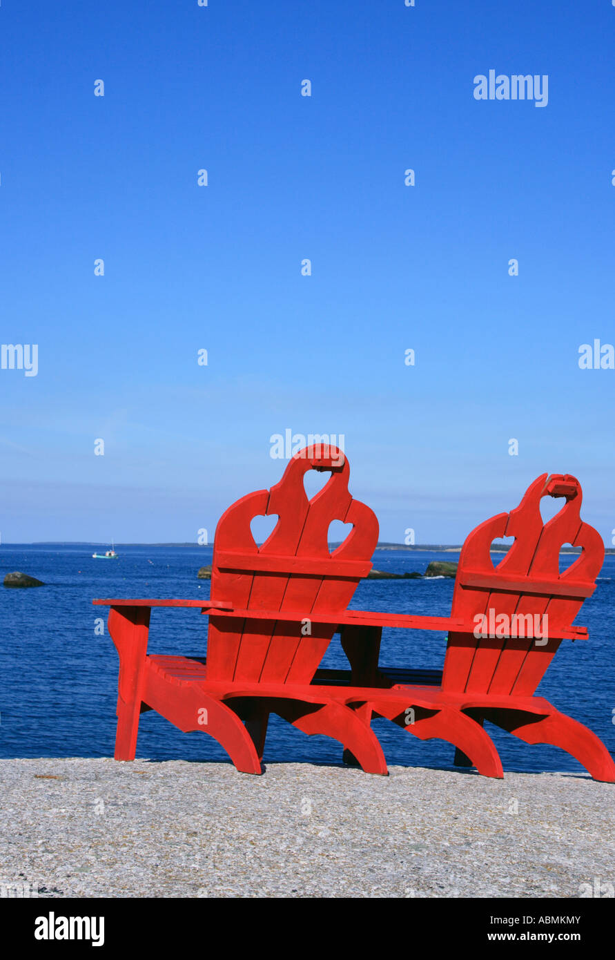 two red Adirondack chairs at the beach, Nova Scotia, NS, Canada. Photo