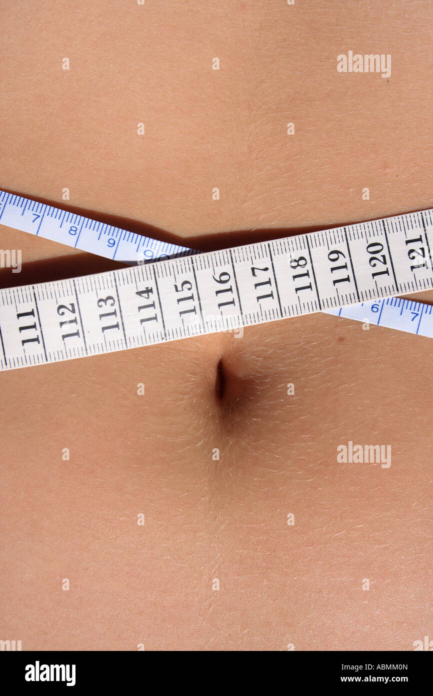 belly of a young woman measuring waist. Photo by Willy Matheisl Stock Photo