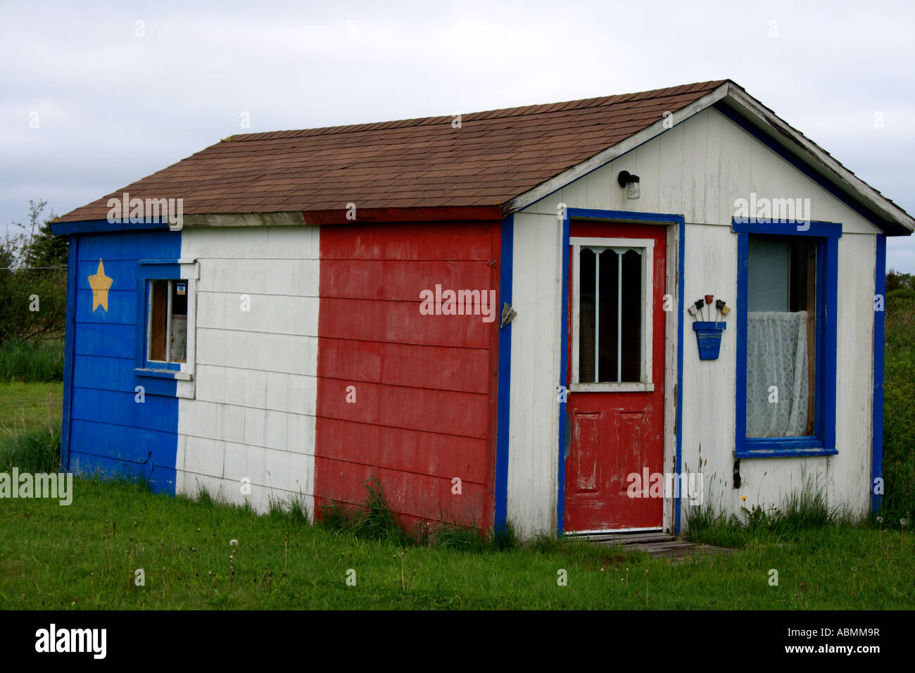 cottage painted in French national coloures, Nova Scotia, Acadian, NS, Canada, North America. Photo by Willy Matheisl Stock Photo