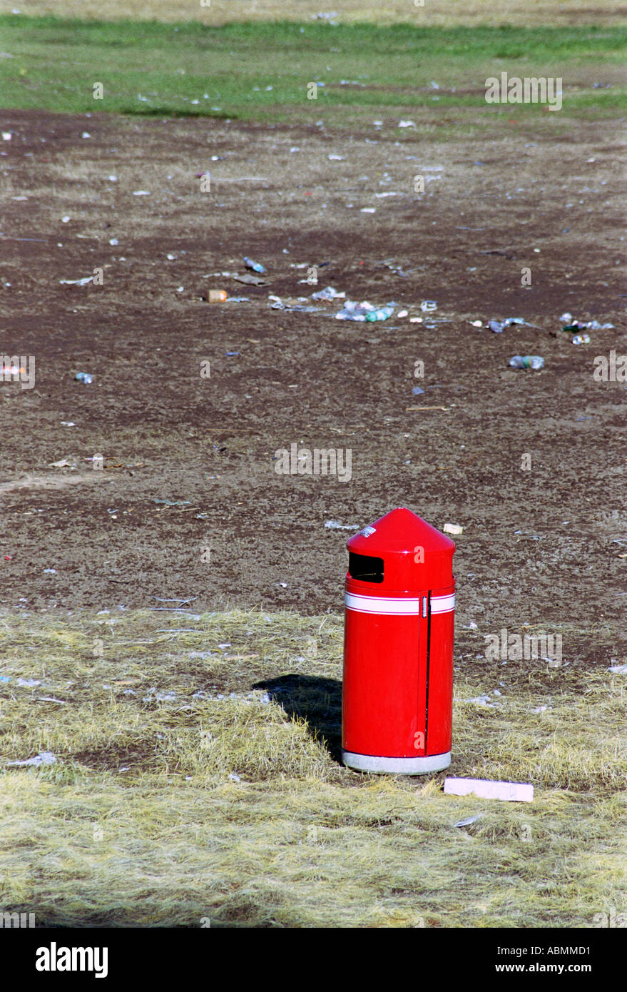 Red rubbish bin abandoned on derelict ground Stock Photo Alamy