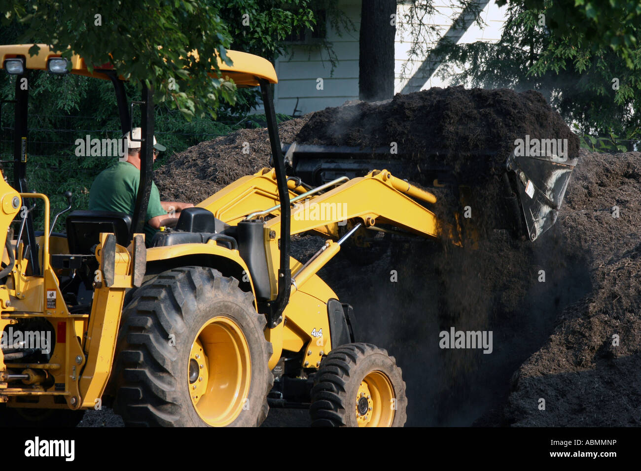 A tractor loading mulch Stock Photo Alamy