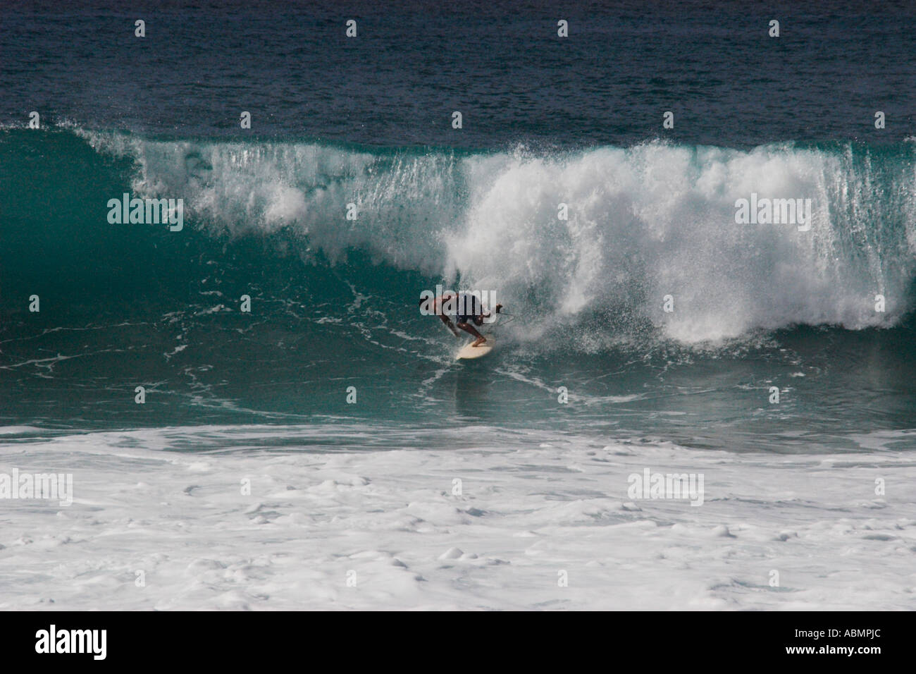 Surfer riding a wave in Pipeline beach world s surfing mecca North Shore Oahu Hawaii Pacific Stock Photo
