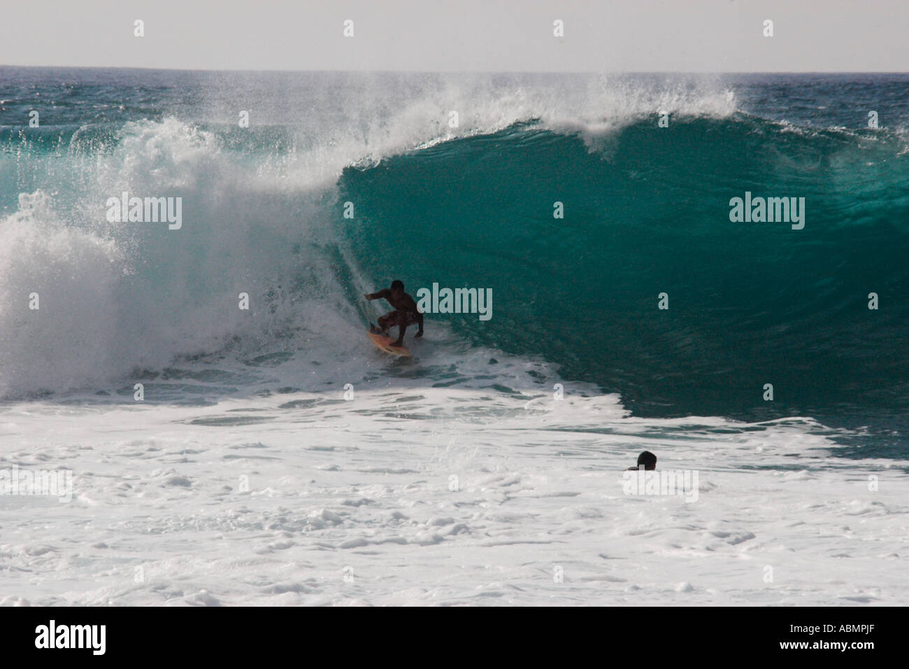 Surfer riding a wave in Pipeline beach world s surfing mecca North Shore Oahu Hawaii Pacific Stock Photo