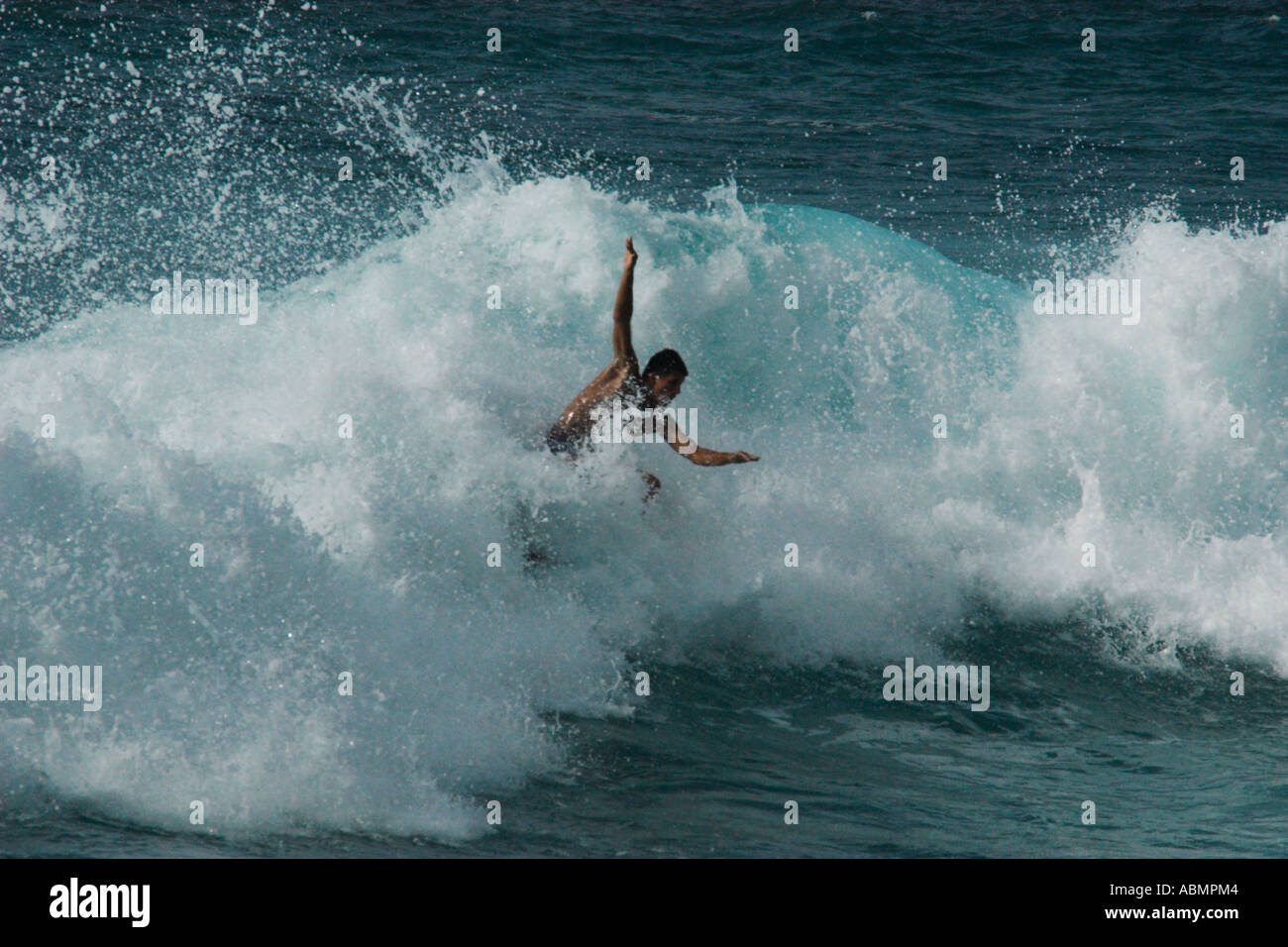 Surfer riding a wave in Pipeline beach world s surfing mecca North Shore Oahu Hawaii USA Stock Photo