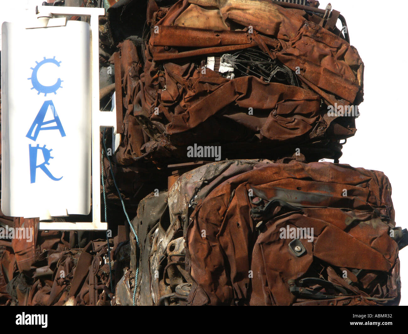 stacked crushed cars used as the wall to a car yard in birmingham